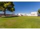 Landscaped green space and community building view at 16053 N 26Th Cir, Phoenix, AZ 85023