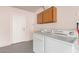 Convenient laundry room with washer, dryer, and cabinets at 16053 N 26Th Cir, Phoenix, AZ 85023