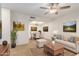 Living room with beige sofa, coffee table, and dining area at 16053 N 26Th Cir, Phoenix, AZ 85023