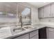 Stainless steel double sink with gray cabinets and tile countertops at 16053 N 26Th Cir, Phoenix, AZ 85023