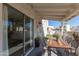 Covered patio with wooden dining table and chairs, overlooking a grassy backyard at 16053 N 26Th Cir, Phoenix, AZ 85023