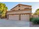 Two-story home with three-car garage and desert landscaping at 13128 N 104Th Pl, Scottsdale, AZ 85260