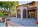 Front entrance with a brick walkway and a large wooden door at 13128 N 104Th Pl, Scottsdale, AZ 85260