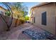Landscaped backyard with brick pathway and rock garden at 13128 N 104Th Pl, Scottsdale, AZ 85260