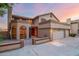 Two-story house with three-car garage, courtyard entry, and arched windows at 13128 N 104Th Pl, Scottsdale, AZ 85260