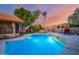 Relaxing pool and patio area with seating and vibrant sunset at 13128 N 104Th Pl, Scottsdale, AZ 85260