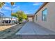 Side exterior view showcasing a long concrete patio and backyard landscape at 5514 E Santa Clara Dr, San Tan Valley, AZ 85140