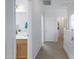 Bright hallway with carpet flooring and access to bathroom at 26853 N 176Th Dr, Surprise, AZ 85387