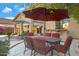 Outdoor dining area with table and chairs under umbrella at 26853 N 176Th Dr, Surprise, AZ 85387