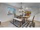 Open dining area with a wooden table and view into the kitchen at 26853 N 176Th Dr, Surprise, AZ 85387