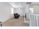 Relaxing loft area with two reclining chairs and a ceiling fan at 26853 N 176Th Dr, Surprise, AZ 85387