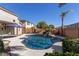 Relaxing kidney-shaped pool with a waterfall and surrounding landscaping at 13635 W Calavar Rd, Surprise, AZ 85379