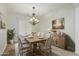 Charming dining room with rustic table, chandelier, and decorative accents at 13635 W Calavar Rd, Surprise, AZ 85379