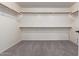 Large walk-in closet with ample shelving and hanging space at 13635 W Calavar Rd, Surprise, AZ 85379