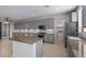 Modern kitchen with large island, granite countertops, and stainless steel appliances at 13635 W Calavar Rd, Surprise, AZ 85379