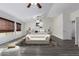 Main bedroom with a king-size bed, sitting area and wood-look floors at 13635 W Calavar Rd, Surprise, AZ 85379