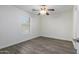 Bright bedroom with ceiling fan and wood-look flooring at 13635 W Calavar Rd, Surprise, AZ 85379