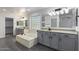 Elegant bathroom with double sinks, soaking tub, and walk-in shower at 13635 W Calavar Rd, Surprise, AZ 85379