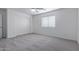 Well-lit bedroom featuring a double-door closet and neutral carpeting at 13635 W Calavar Rd, Surprise, AZ 85379