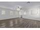 Bright living room featuring wood-look floors and high ceilings at 13635 W Calavar Rd, Surprise, AZ 85379
