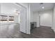 Home hallway with wood-look floors and access to bedrooms at 13635 W Calavar Rd, Surprise, AZ 85379