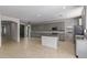 Open concept kitchen with gray cabinets, granite island, and breakfast bar at 13635 W Calavar Rd, Surprise, AZ 85379
