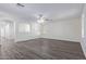 Spacious living room featuring wood-look flooring and neutral walls at 13635 W Calavar Rd, Surprise, AZ 85379