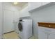 Laundry room with washer, dryer, cabinets, and extra counter space at 13635 W Calavar Rd, Surprise, AZ 85379