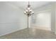 Elegant dining room, featuring a chandelier and herringbone floors at 13635 W Calavar Rd, Surprise, AZ 85379