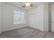 Well-lit bedroom with neutral carpeting, double door closet and window blinds at 13635 W Calavar Rd, Surprise, AZ 85379