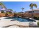 Inviting kidney-shaped pool with waterfall feature and a spacious patio at 13635 W Calavar Rd, Surprise, AZ 85379
