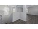 Upstairs hallway with wood-look flooring and arched doorways at 13635 W Calavar Rd, Surprise, AZ 85379