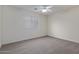 Spacious bedroom with ceiling fan and neutral carpeting at 13635 W Calavar Rd, Surprise, AZ 85379