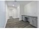 Hallway with built-in desk and grey cabinets at 13635 W Calavar Rd, Surprise, AZ 85379