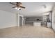 Open kitchen with gray cabinets, granite island, and access to living area at 13635 W Calavar Rd, Surprise, AZ 85379