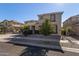 Two-story house with stone and stucco exterior, palm trees, and a landscaped yard at 13635 W Calavar Rd, Surprise, AZ 85379