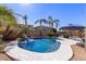 Stunning kidney shaped pool with waterfall feature and lush landscaping at 13635 W Calavar Rd, Surprise, AZ 85379