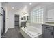 Spa-like bathroom featuring a soaking tub, double vanity, and a large shower at 13635 W Calavar Rd, Surprise, AZ 85379