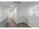 Upstairs hallway with gray cabinets and wood-look flooring at 13635 W Calavar Rd, Surprise, AZ 85379