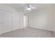 Well-lit bedroom featuring double door closet and carpet flooring at 13635 W Calavar Rd, Surprise, AZ 85379