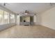Bright living room with tile floors, built-in entertainment center, and large windows at 13635 W Calavar Rd, Surprise, AZ 85379