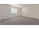 Bright bedroom with carpet flooring, window blinds, and ceiling fan at 13635 W Calavar Rd, Surprise, AZ 85379