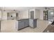 Island kitchen with granite countertops and gray cabinets at 13635 W Calavar Rd, Surprise, AZ 85379