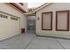 Side entrance with wrought iron gate and access to garage at 13635 W Calavar Rd, Surprise, AZ 85379