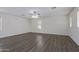 Spacious bedroom with wood-look floors and ceiling fan at 13635 W Calavar Rd, Surprise, AZ 85379