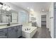 Spacious bathroom boasting a large soaking tub and double vanity at 13635 W Calavar Rd, Surprise, AZ 85379