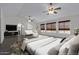 Main bedroom with a king-size bed and sitting area at 13635 W Calavar Rd, Surprise, AZ 85379