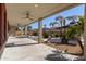 Covered patio overlooking the backyard with pool and spa at 13635 W Calavar Rd, Surprise, AZ 85379