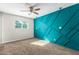 Bedroom with teal geometric accent wall and ceiling fan at 101 W Shannon St, Chandler, AZ 85225