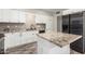 Modern kitchen with granite countertops, white cabinets, and black appliances at 101 W Shannon St, Chandler, AZ 85225